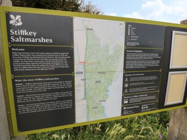 An informational signboard about Stiffkey Saltmarshes with a map and text at Primrose Cottage in Stiffkey