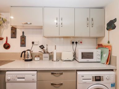 A kitchen with appliances and utensils at Yew Tree Cottage in Stoke Fleming