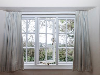 A window with curtains at Yew Tree Cottage Stoke Fleming
