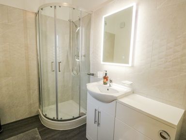 A bathroom with a shower and sink at 2 Mountain View in Talwrn near Llangefni
