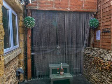 An outdoor area with a table and plants at Crabtree Cottage Suffield near Scalby