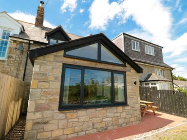 Stone house extension with large window and triangular upper window at 24 Hauxley Links Low Hauxley near Amble