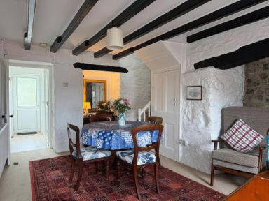 A dining room with a table and chairs at Derlwyn in Newport, Pembrokeshire