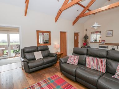A living room with sofas and a coffee table at Y Felin in Cardigan, Ceredigion