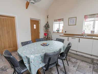 A dining room with a table and chairs at Y Felin in Cardigan, Ceredigion