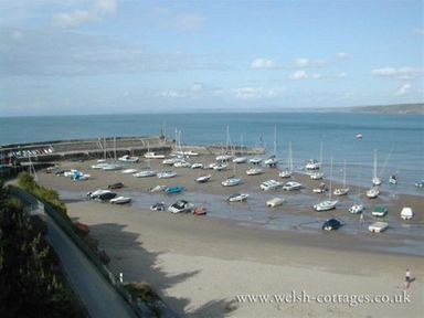 A harbor with boats resting on the sand at low tide near the sea at Pond Cottage in New Quay Ceredigion
