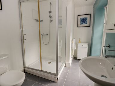 A bathroom with a shower and sink at Dewi Villa in Aberarth, Ceredigion