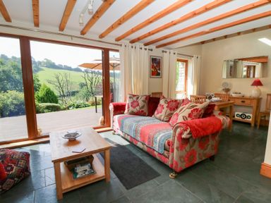 A living room with a sofa and coffee table at Dan Castell Cottage in Llandeilo, Carmarthenshire