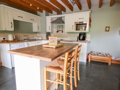 A kitchen with cabinets, a countertop, and a sink at Dan Castell Cottage, Llandeilo, Carmarthenshire
