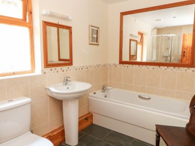 A bathroom with a sink and bathtub at Dan Castell Cottage in Llandeilo, Carmarthenshire