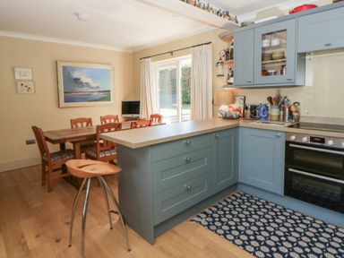 A kitchen with dining area and cooking appliances at Dolwylan Newport, Pembrokeshire