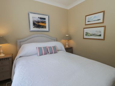 A bedroom with a bed and artwork at Dolwylan Newport, Pembrokeshire