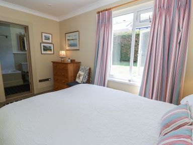 A bedroom with a bed and dressing table at Dolwylan in Newport, Pembrokeshire