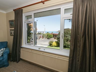 A living room with a view of the sea at Dolwylan Newport, Pembrokeshire