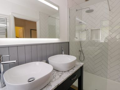 A bathroom with two basins and a shower at Delyn Aur Tresaith, Ceredigion