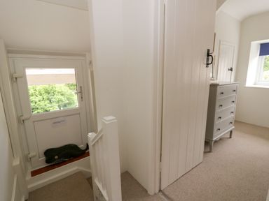 A hallway with a door and window at Little Barn Cottage Dinas Cross Pembrokeshire