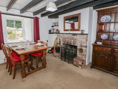 A dining room with a table and chairs at Panteg, Cardigan Llangoedmor Cardigan