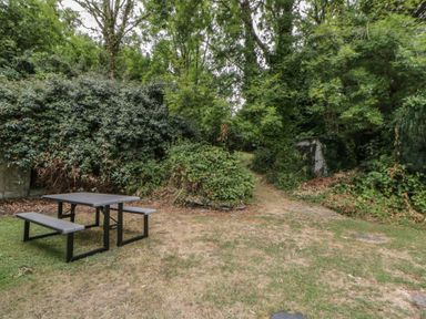 A picnic table with benches in a garden at Panteg, Cardigan Llangoedmor Cardigan