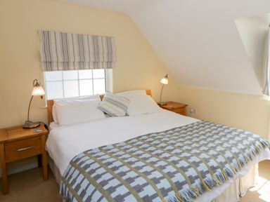 A bedroom with a double bed and bedside table at Beach Retreat in Aberporth