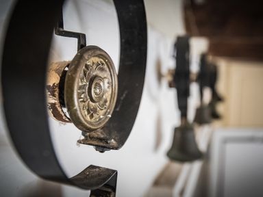A close up of vintage metal doorbells mounted on a wall at The Rock House in Fishguard Pembrokeshire