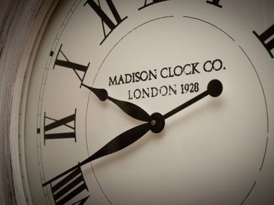 A close-up of a clock face with roman numerals and black hands at The Rock House in Fishguard Pembrokeshire