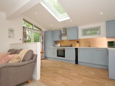 A kitchen with cabinets and a stove at The Hideout in Lanreath