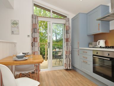 A kitchen with a table and chairs at The Hideout in Lanreath