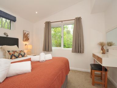 A bedroom with a bed and desk at The Hideout in Lanreath
