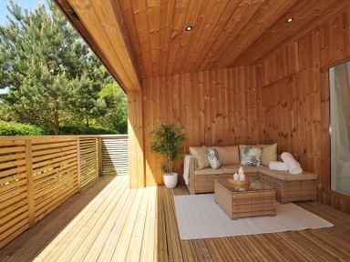 An outdoor area with a sofa and coffee table at The Hideout in Lanreath