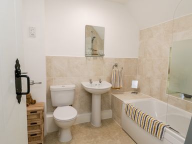 A bathroom with a toilet sink and bathtub with towels at Parva in Great Broughton near Stokesley