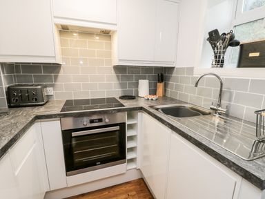 A kitchen with a stove oven toaster sink utensils knives and eggs on countertop at Parva in Great Broughton near Stokesley