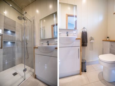 A bathroom with a shower area, sink with cabinet, towel, trash bin, and toilet at Wren Lodge in Gargrave