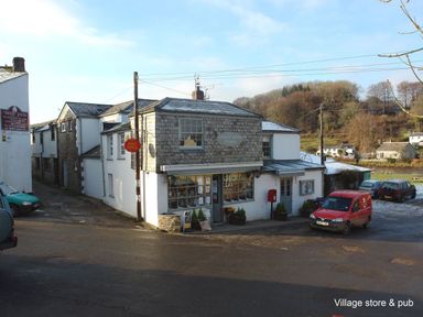 A village store with a post office sign and a red delivery van parked outside at Ribby Barn in Lerryn