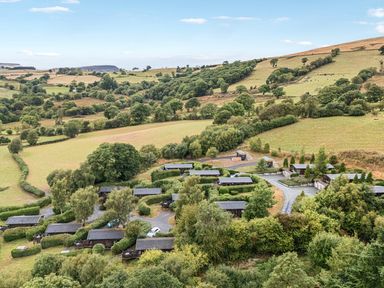 A view of cabins and fields at Barn Owl Lodge in Rhayader