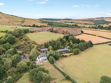An aerial view of a house and fields at Barn Owl Lodge in Rhayader