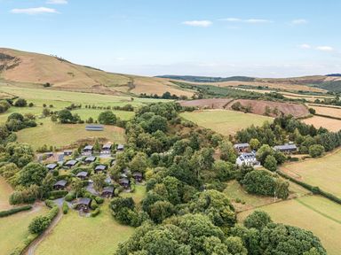 An aerial view of lodges and fields at Barn Owl Lodge in Rhayader