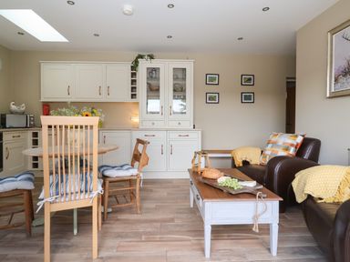 A kitchen with dining furniture and a couch at 1 Church Barns Pocklington