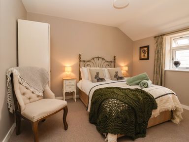 A bedroom with a bed and chair at 1 Church Barns Pocklington