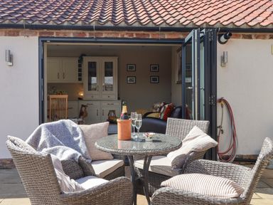 An outdoor seating area with chairs and a table at 1 Church Barns Pocklington