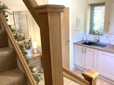 A kitchen with a sink and storage at Larchwood Lodge in Ellon