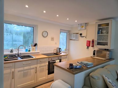 A kitchen with a sink, stovetop, oven, microwave, countertop, and cabinets at 17 River Banks in Liskeard