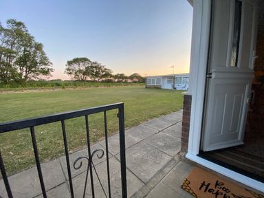A view of a lawn and trees from an entrance at 246 California Road, California, Norfolk
