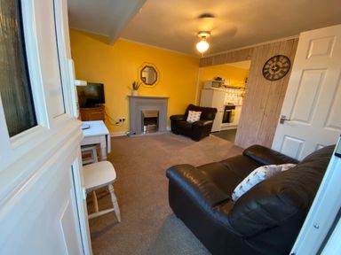 A living room with a television and fireplace at 246 California Road California, Norfolk