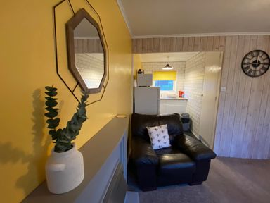 A living room with a couch and mirror at 246 California Road, California, Norfolk