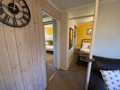A hallway with a clock and doorways to rooms at 246 California Road, California, Norfolk