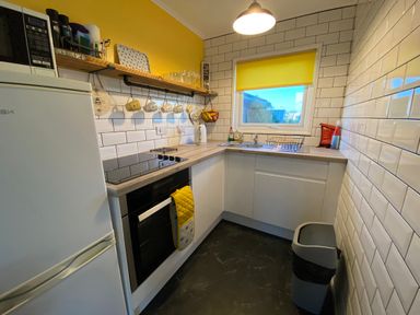 A kitchen with essential appliances and a window at 246 California Road in California, Norfolk