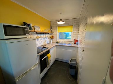 A kitchen with a refrigerator, microwave, and sink at 246 California Road, California, Norfolk