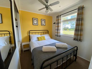 A bedroom with a bed and a bedside table at 246 California Road, California, Norfolk