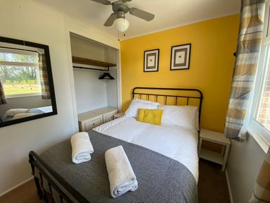 A bedroom with a bed and mirror at 246 California Road, California, Norfolk