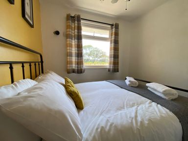 A bedroom with a bed and window at 246 California Road, California, Norfolk